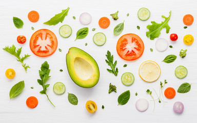 Food pattern with raw ingredients of salad on white wooden background.