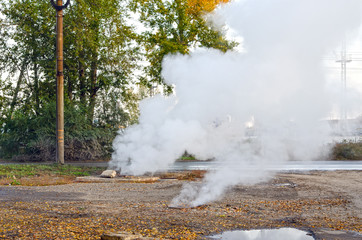 Damage to the underground hot water pipeline. Steam rises from the sewer