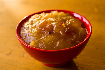 Homemade apple jamTransparent Apple sweet homemade jam in the red ceramic bowl