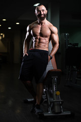 Fototapeta na wymiar Portrait Of Caucasian Instructor In Fitness Center Gym