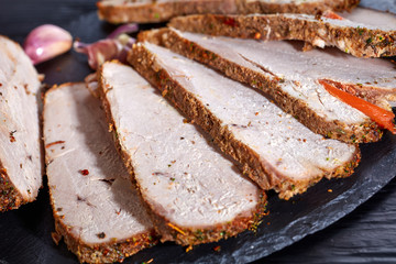 Herb crusted ham cut in slices, close up