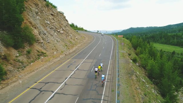 Aerial view of road cyclists and cars. Red Bull Trans-Siberian Extreme 4k