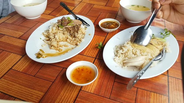 time lapse pan shot close-up asian man eating Khao Man Kai, Chicken Rice with sauce and soup. Thai traditional food. 
