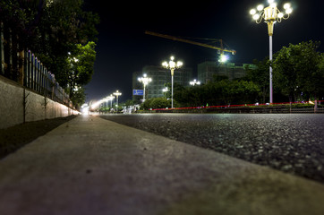 Fototapeta na wymiar Empty asphalt road and modern skyline at night