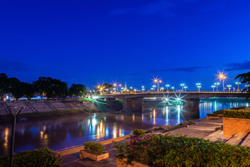 Beautiful light on the Nan River at night on the bridge (Naresuan Bridge) in Phitsanulok City, Thailand.