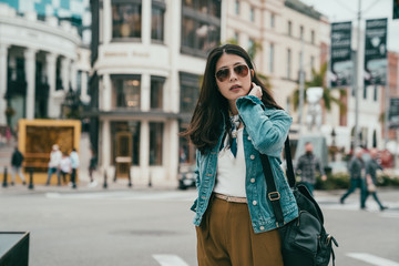 pretty lady stopped while crossing road