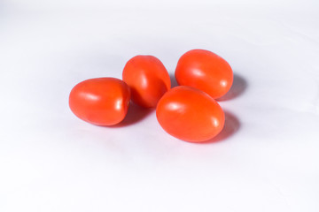 Group of red tomatos on a white background