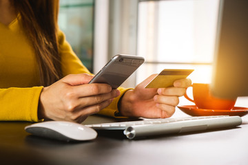close up of hand using tablet ,laptop, and holding smartphone with credit card online banking payment communication network,internet wireless application development sync app,virtual graphic  icon dia