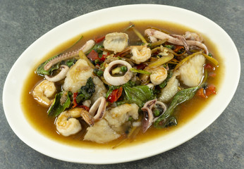Fried stir spicy sea food on stone background. Top view. .