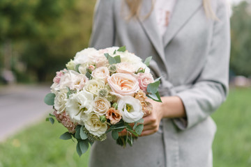 spring mood. Young girl holding a beautiful wedding bouquet. flower arrangement with white and Pastel color flowers.