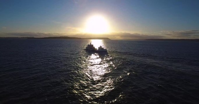 Ship sailing at sunset. Islands in the background