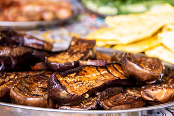 Delicious baked eggplants on the grill street food