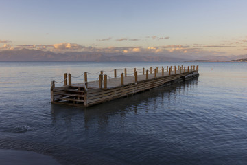 wooden pier in the sea against the beautiful sunset sky, a place for relaxation and meditation