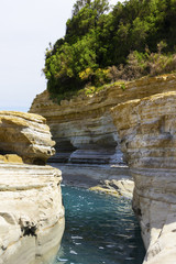 background image of rocky seashore on different Islands of Greece, Rhodes, KOs, Santorini,...