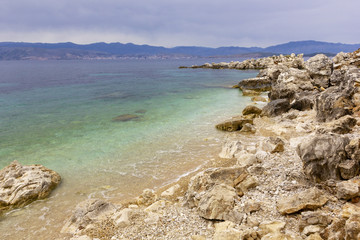Fototapeta na wymiar background image of rocky seashore on different Islands of Greece, Rhodes, KOs, Santorini, Halkidiki, Crete, Simi, Corfu
