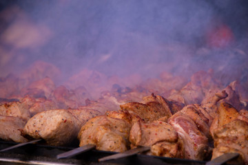 Delicious grilled shish kebab on skewers with smoke