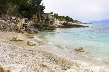 background image of rocky seashore on different Islands of Greece, Rhodes, KOs, Santorini,...