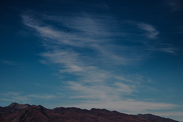 Mountain range and blue sky with plane