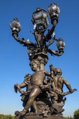 Fototapeta na wymiar Statues on Pont Alexandre III (Alexander III Bridge) over the River Seine, Paris, France