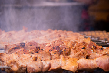 Close-up delicious grilled shish kebab on skewers with smoke