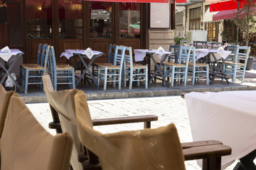a small bright cafe in the shade of grapes in the Mediterranean, closed in the hour of the Siesta, the day when the hottest sun