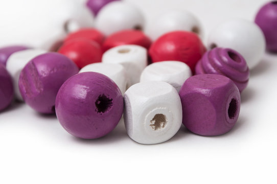 closeup of purple wooden beads on white background