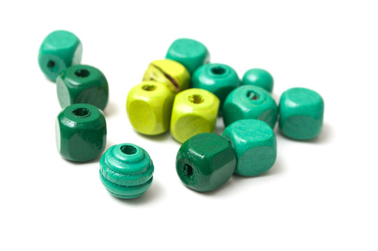 closeup of green wooden beads on white background