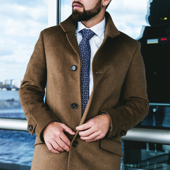 The man in a fashionable business coat
