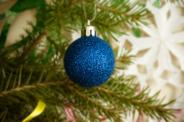 blue shiny Christmas tree decoration on spruce