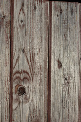 background old faded and cracked wooden boards of brown color faded from the sun