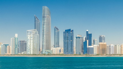 Fototapeta na wymiar View of high skyscrapers on a corniche in Abu Dhabi stretching alongside the business center timelapse.