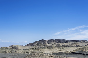 Fototapeta na wymiar Desert and mountain over blue sky and white clouds on altiplano