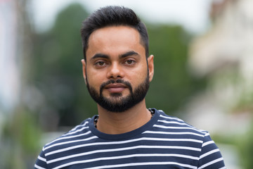 Young bearded Indian man in the streets outdoors