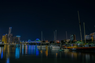 Fototapeta na wymiar Boats near city at night