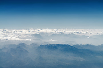 Sunny view of atmosphere above the clouds in Europe.