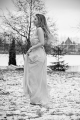 Winter holiday concept. Inspiration and fairy cold time. Woman in fashionable evening dress at park . Pretty nice lady outdoor, holiday days, snowy magical christmas time 