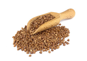 Buckwheat on wooden scoop isolated on white background