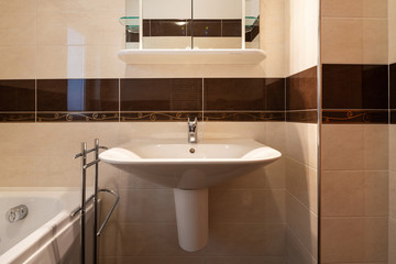 Front view bathroom with brown tiles