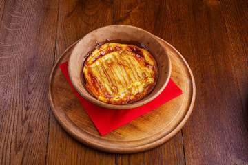 Sweet rice pudding baked in pottery on a red nupkin