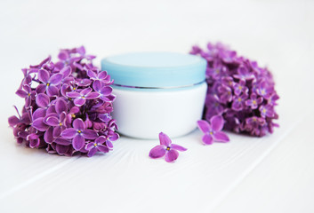 lilac flowers and cosmetic cream