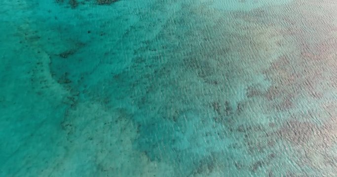 Aerial view of turquoise ocean water with reef, Caribbean
