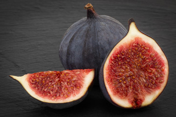 fresh ripe figs on dark background close up