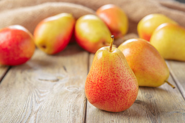 Ripe pears on rustic wooden table