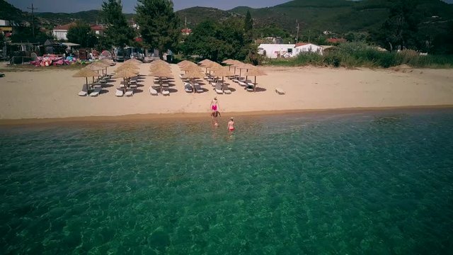 Family on beach aerial shot, Sithonia, Greece