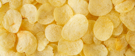 crispy potato chips snack texture background top view - Powered by Adobe