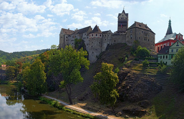 Fototapeta na wymiar Panorama of Loket Castle at the top of the rocky hill with Ohre River and colorful medieval buildings by summer sunny day. Bohemia, Sokolov, Karlovarsky Region, Czech Republic