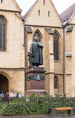The statue of Loi Georg Daniel Teutsch in front of Lutheran Cathedral of Saint Mary in a rainy day....