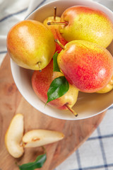 organic pears laying down on a lightly dotted kitchen cloth