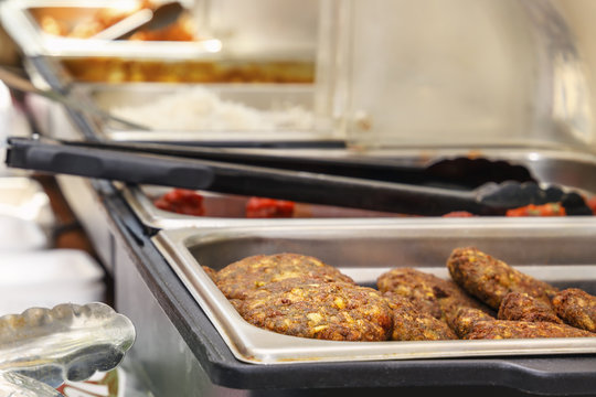 Fresh fried cutlets - burgers lie in the tray of a street fast food shop. Copy space