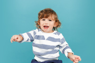 Portrait of happy joyful beautiful little boy, studio shot on blue